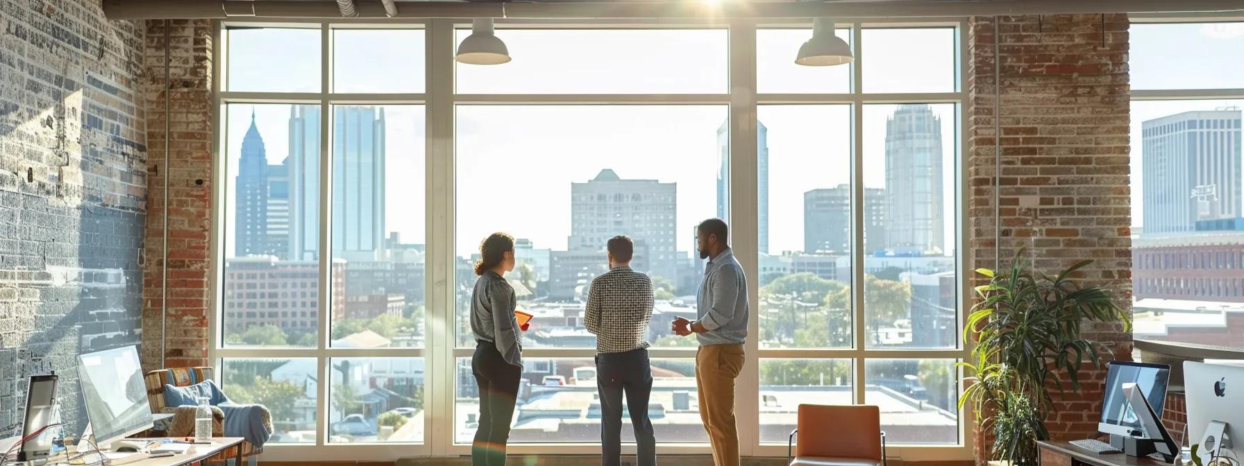 a modern, bustling urban office space featuring a team of professionals collaborating near a large window, with a clear view of savannah's skyline, symbolizing on time air's commitment to rapid ac service across diverse neighborhoods.
