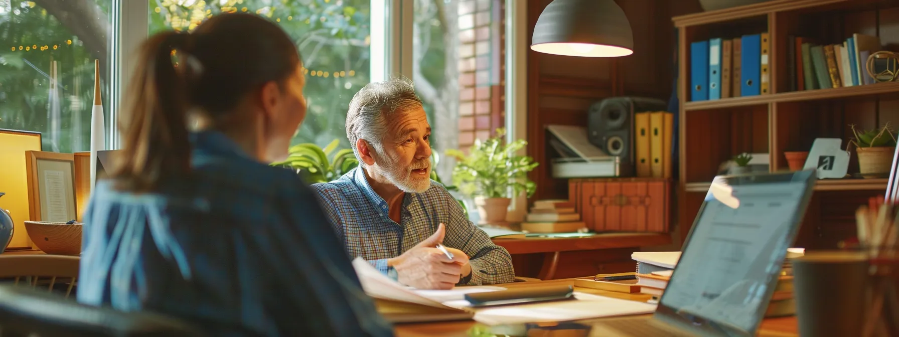 a homeowner discussing maintenance agreements with a knowledgeable hvac contractor in a well-lit, organized home office.